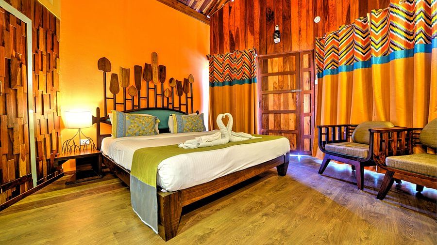 room with a king size bed and quirky yellow interiors