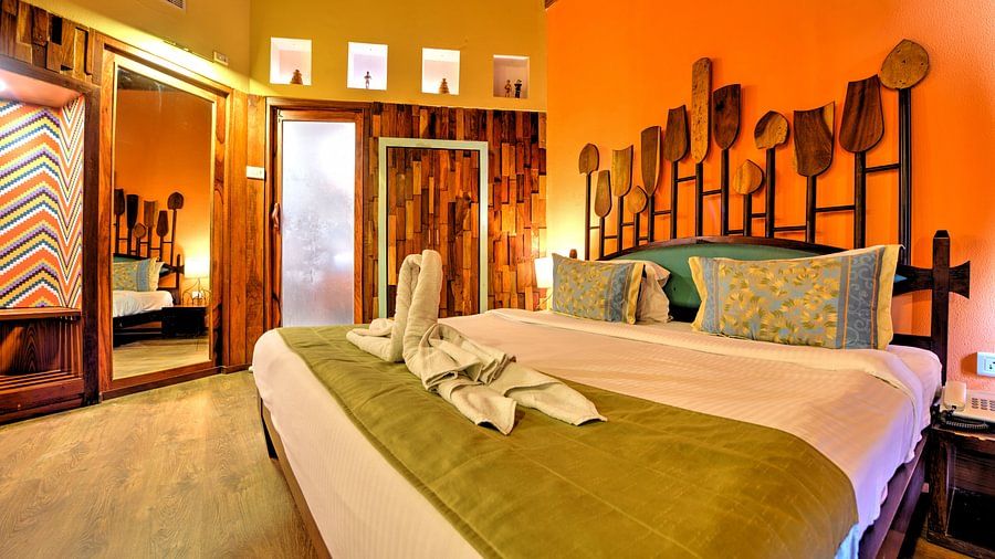 room with a king size bed and quirky yellow interiors