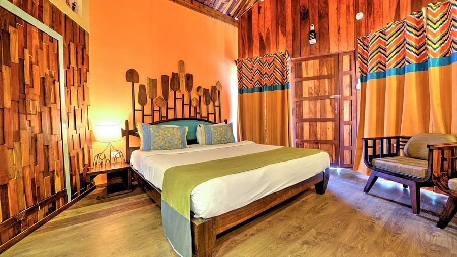 room with a king size bed and quirky yellow interiors