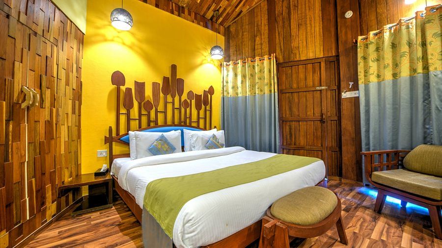 room with a king size bed and quirky yellow interiors