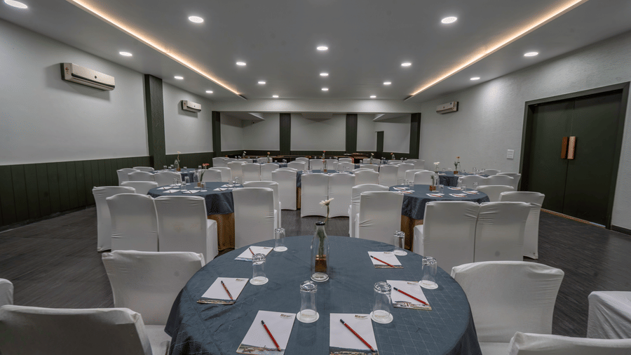 Conference room with grey round tables and chairs set up for a meeting at The Golden Tusk, Jim Corbett