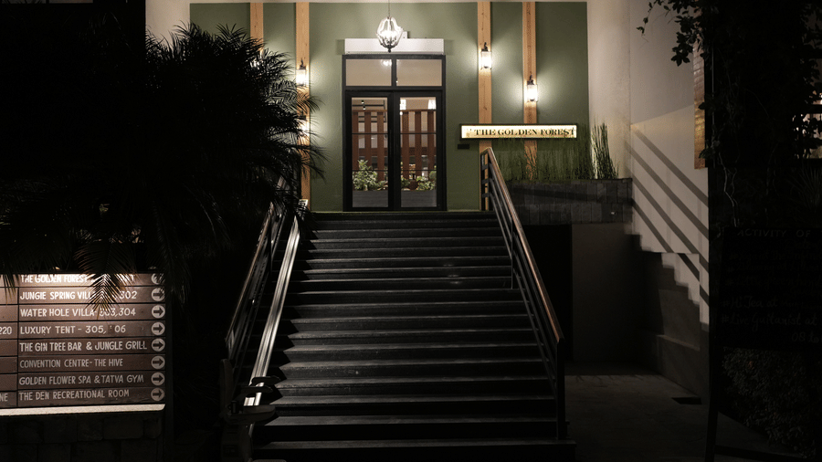 An outdoor staircase leading to a building entrance at night at The Golden Tusk, Jim Corbett