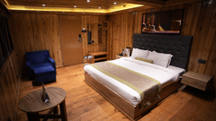 Luxurious wooden room with a king-size bed and mountain view