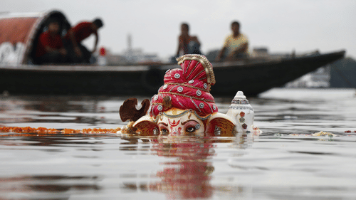 Lord Ganesha Statuette Submerged on Body of Water