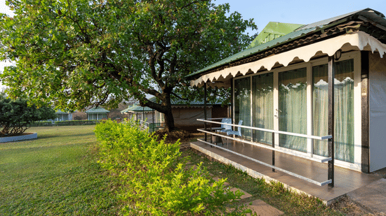 Colonial-style building with a long porch and green surroundings at Nature Trails Durshet