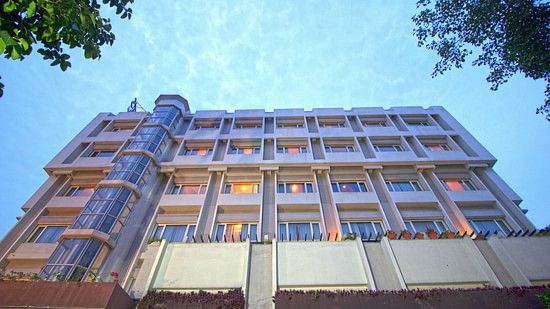 IRA Hotel Bhubaneswar huge building with soften pastel colour exterior and big window panes 
