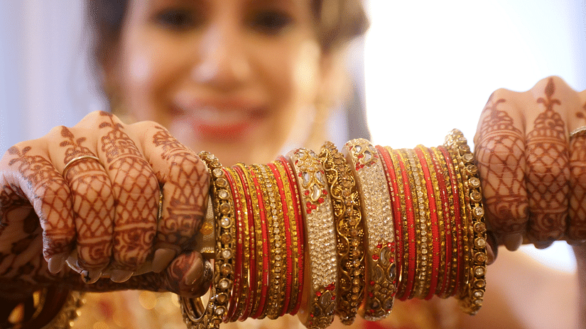 A bride looking at a set of bangles - Hablis Hotel, Chennai