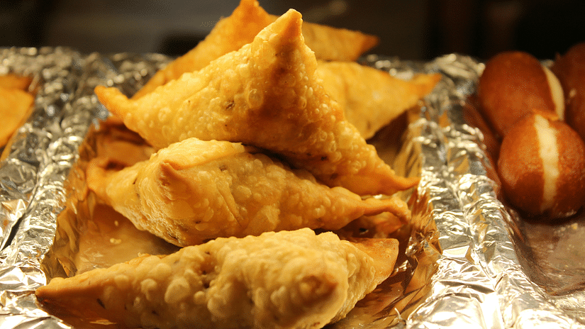 a close up shot of samosas kept on a plate ready for serving