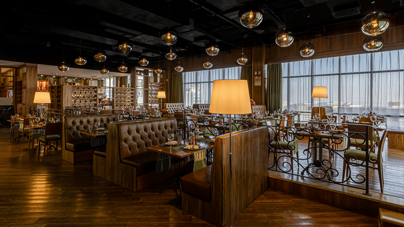 Seating arrangements at Fogo No Chão restaurant, one of the best places to eat in Addis Ababa, with small chandeliers on the roof at Ramada by Wyndham Addis