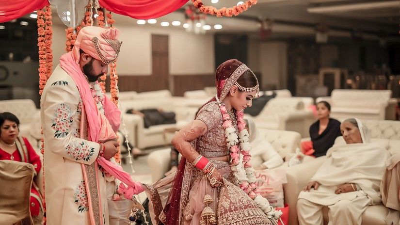 An Indian couple getting married inside a banquet hall 