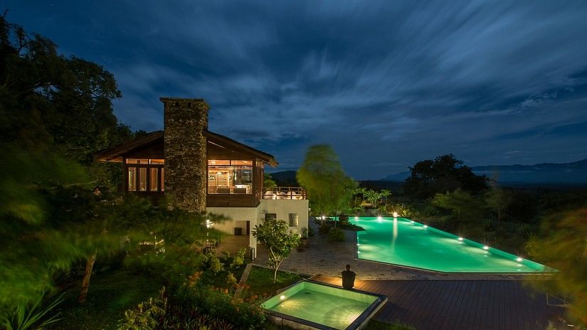 our resort with swimming pool in Bandipur lit up at night