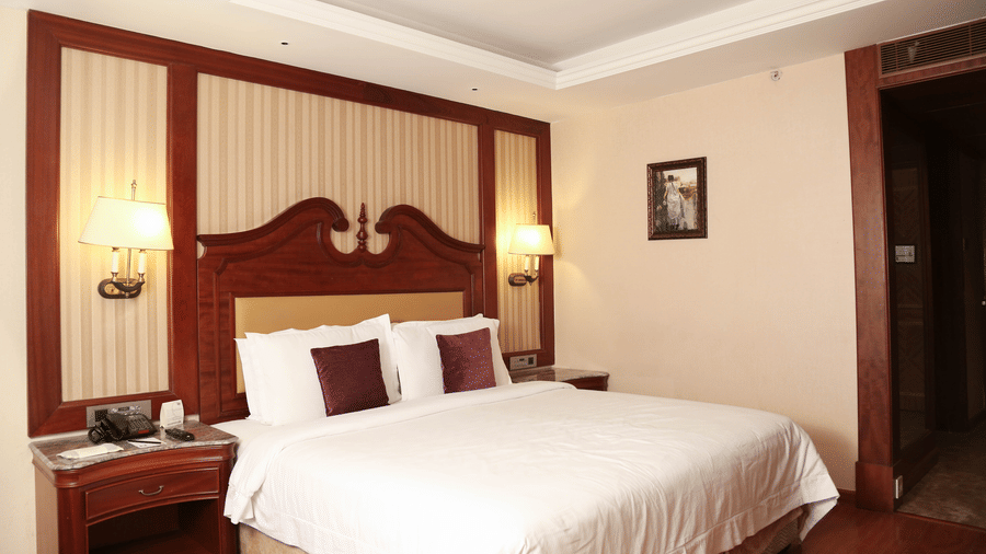Cosy room with king size bed and modern interiors atstay stay rooms at hablis hotel, chennai.