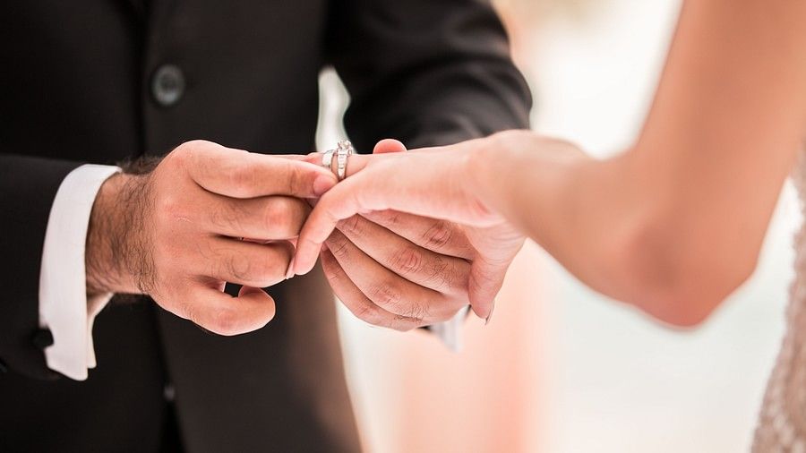 close up image of the bride and groom exchanging wedding rings - Maikhao Dream Villa Resort & Spa, Phuket