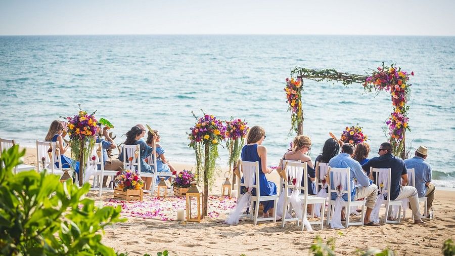 image of a group of people seated in the wedding setup waiting for the ceremony to begin at maikhao dream villa resort & spa, phuket 