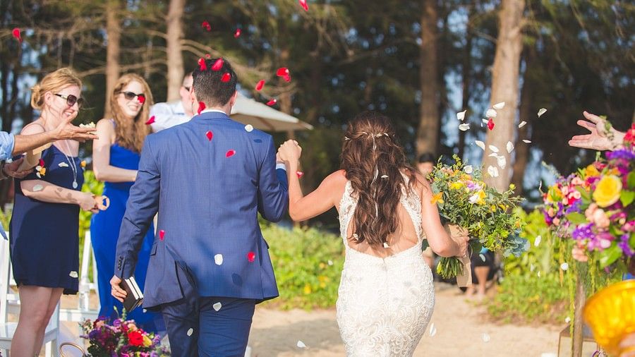 back shot featuring the couple holding hands walking towards the guests - Maikhao Dream Villa Resort & Spa, Phuket