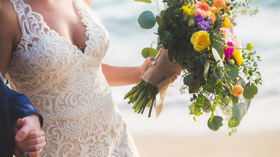 close up image of the bride and the flower bouquet in her hand - Maikhao Dream Villa Resort & Spa, Phuket