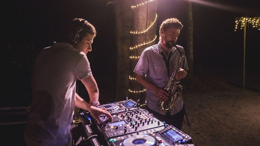 image of the dj artist and a person playing the saxophone - Maikhao Dream Villa Resort & Spa, Phuket