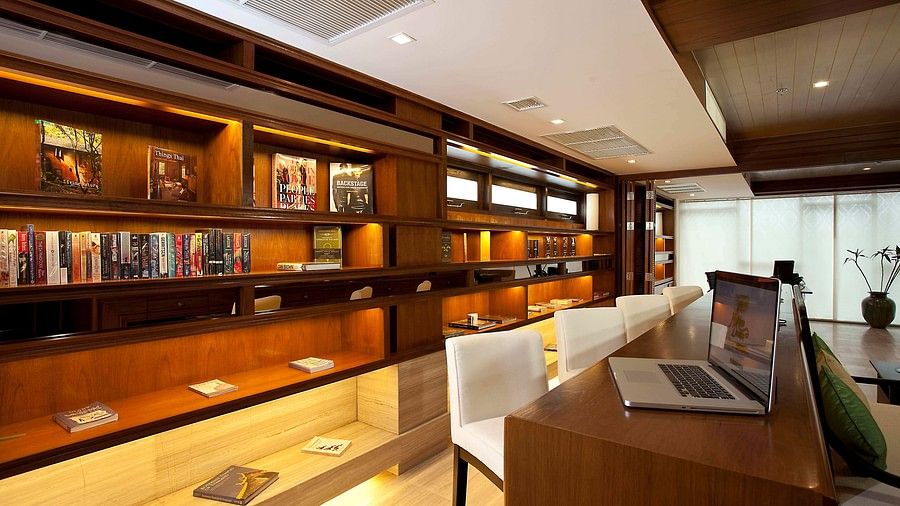 image of the business centre and library from a corner view with a table in front of the book shelf - Maikhso Dream Villa Resort & Spa, Phuket