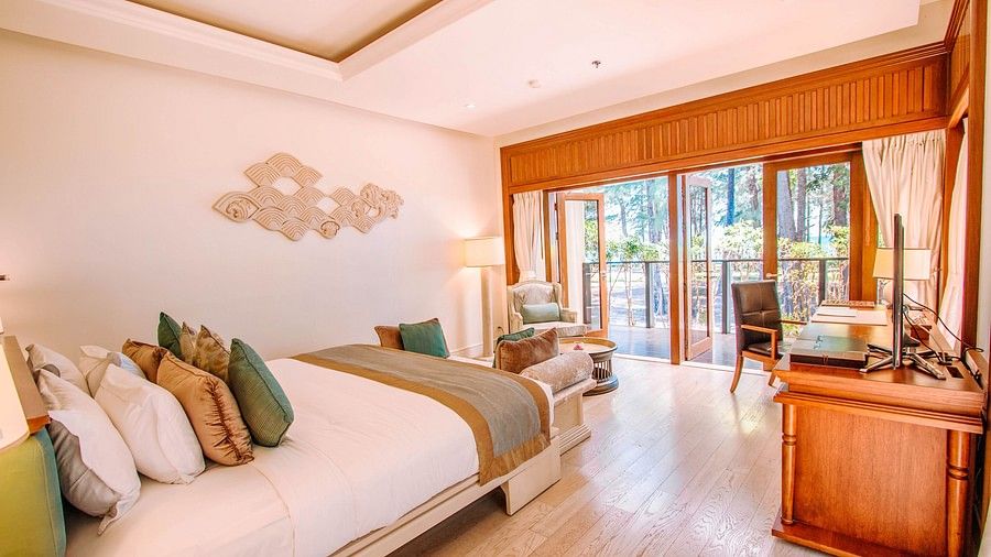 image of a bedroom featuring a king size bed with a lot of cushions on it - two bedroom private pool beachfront villa