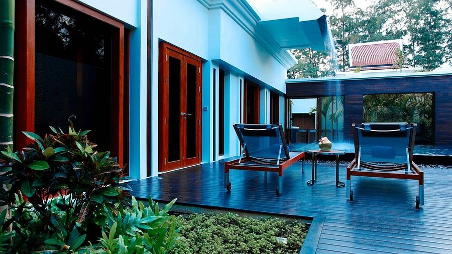 private sit out area with two sun loungers kept on a late evening - three bedroom private pool villa
