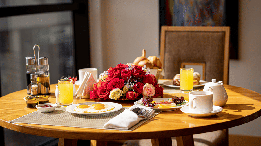 An overview of a dining table with many cutlery and food items on it inside The Chef’s Club at Ramada by Wyndham Addis, Addis Ababa.