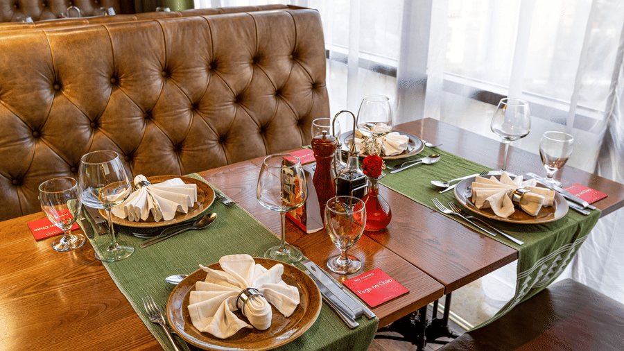 An overview of the sofa seating with a table in the centre having many items on it inside FOGO NO CHÃO restaurant - Ramada by Wyndham Addis, Addis Ababa