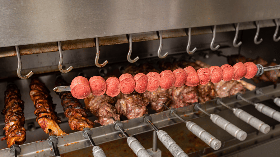 A close up shot of different types of meat being Grilled at fogo no chao - Ramada by Wyndham Addis, Addis Ababa