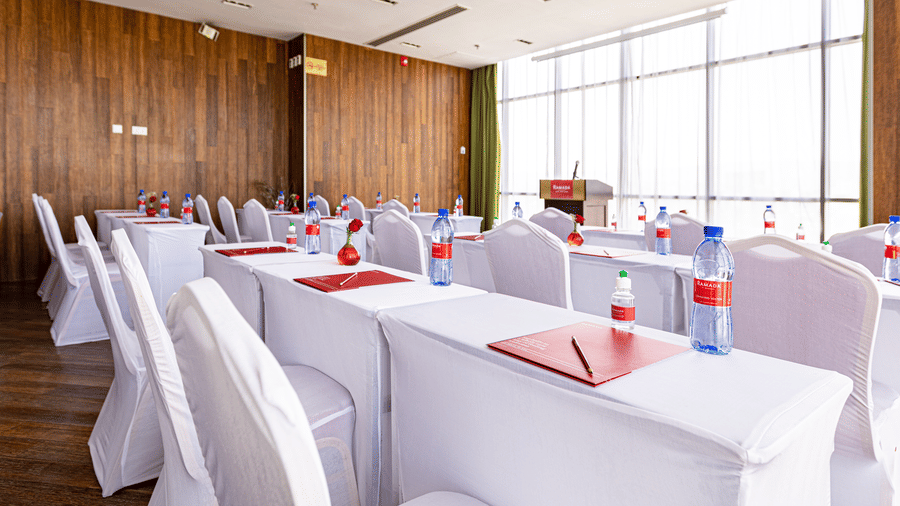 An overview of a meeting room with many tables and chairs in view - Ramada by Wyndham Addis, Addis Ababa.