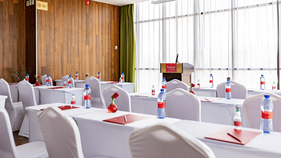 An overview of a meeting room with many tables and chairs in view - Ramada by Wyndham Addis, Addis Ababa.