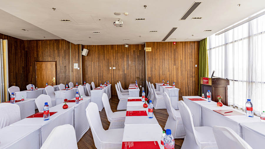 An overview of a meeting room with many tables and chairs in view - Ramada by Wyndham Addis, Addis Ababa.