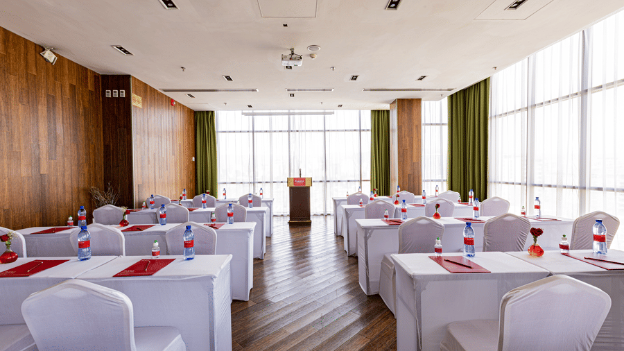 An overview of a meeting room with many tables and chairs in view - Ramada by Wyndham Addis, Addis Ababa.