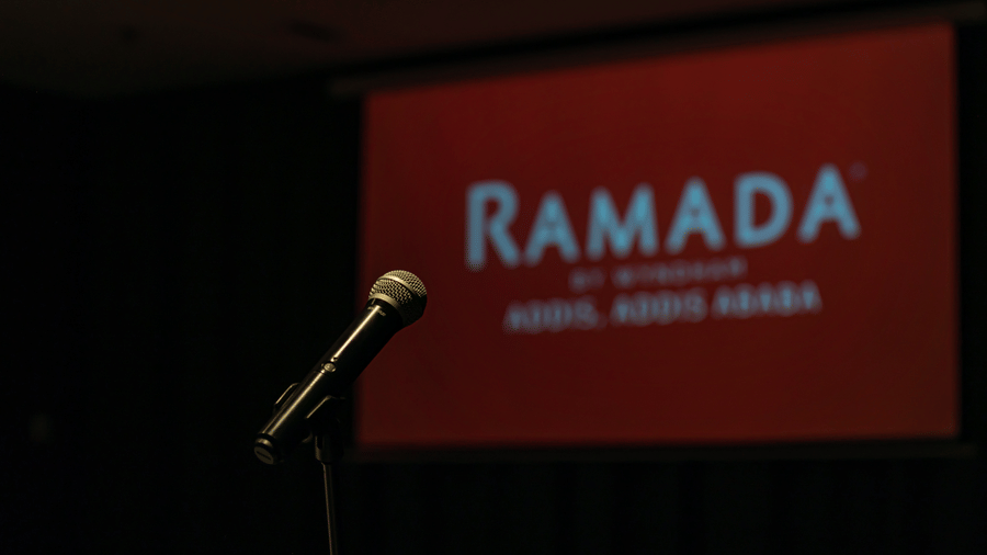 A view of the projector screen with the words Ramada on it as seen from the podium with a mic - Ramada by Wyndham Addis, Addis Ababa