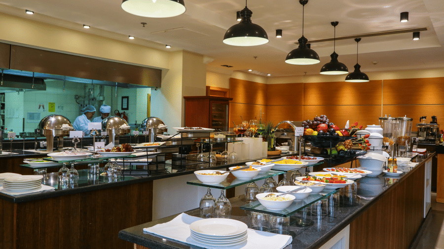 An overview of the buffet area with many items to choose from inside one of the restaurants - Ramada by Wyndham Addis, Addis Ababa.