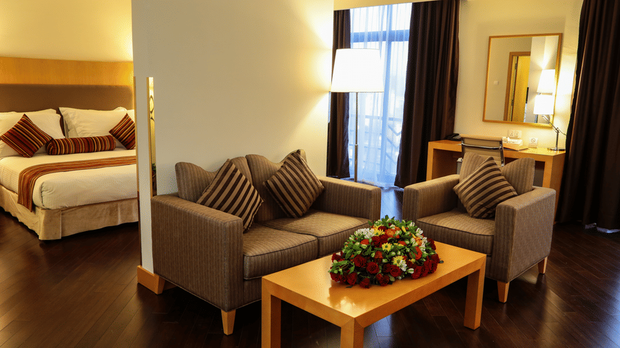 A view of a bedroom at Ramada by Wyndham Addis with both the living area and bedroom beautifully in view.