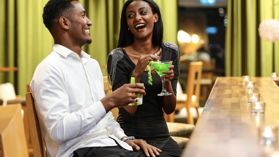 An overview of the bar area of Ramada by Wyndham Addis, Addis Ababa with a couple holding their drinks.