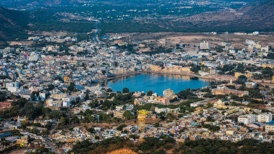 An aerial view of a Pushkar lake surrounded by buildings