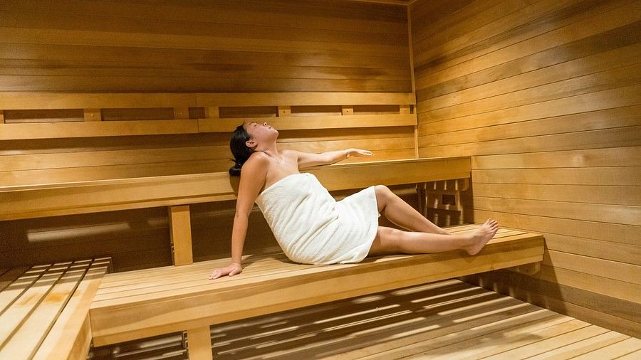 a woman relaxing in the sauna at YO1 Longevity & Health Resorts, Catskills