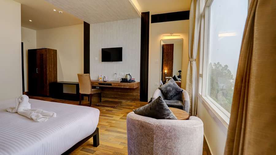 view of king size bed and TV of a Deluxe Room Banari Regency by Summit, Namchi