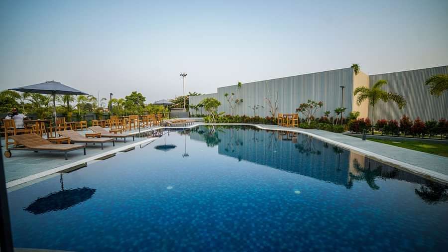 The outdoor swimming pool at Singalila Club with lounging chair setup beside it