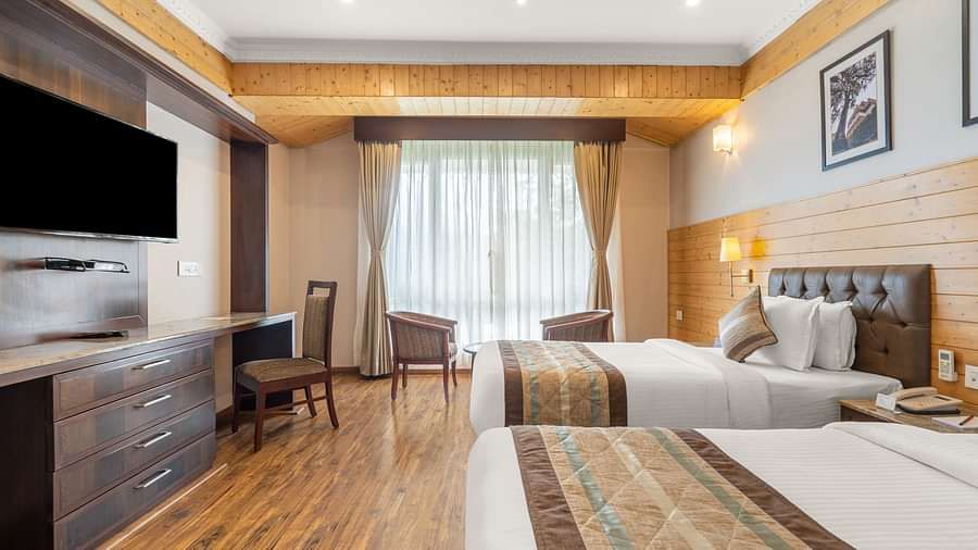 A room at Summit Alpine Abode with a twin beds, a television and French windows