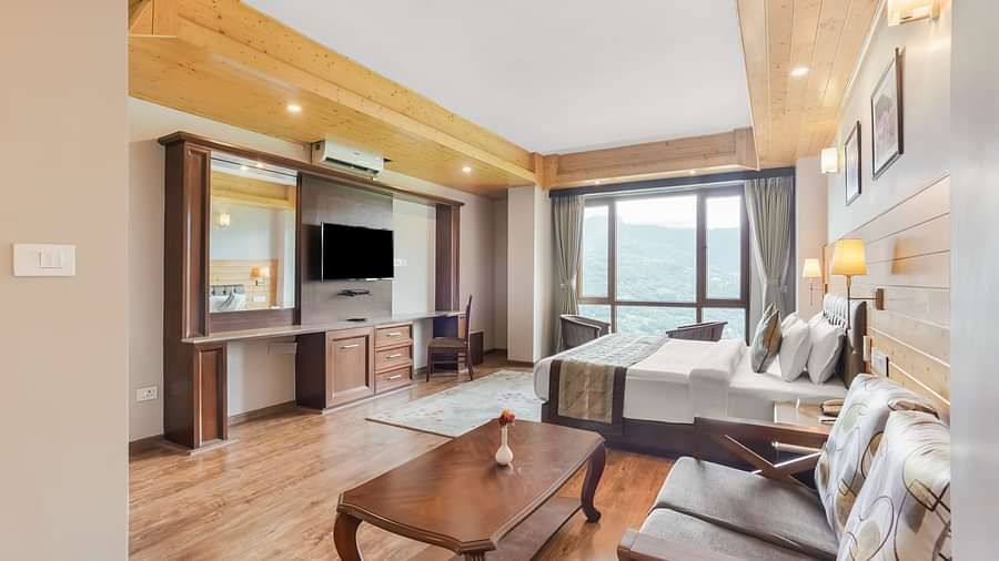 Suite at Summit Alpine Abode with a double bed, a coffee table, sofa seating and a television