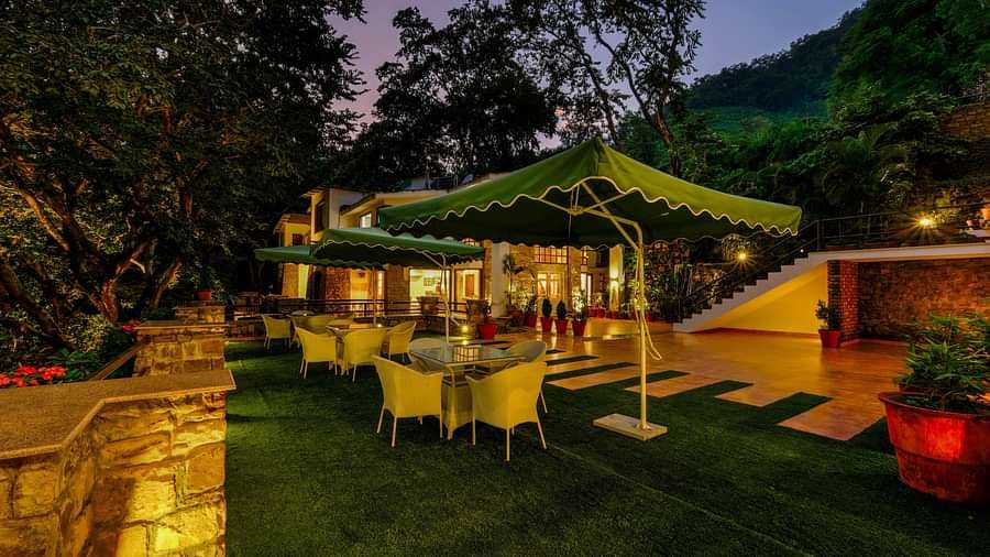 Night viuew of the seating area with shades  at Summit By The Ganges Beach Resort & Spa, Rishikesh