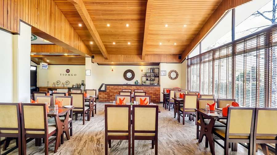 Tsomgo restaurant features cozy lighting, wooden tables and chairs, and culinary arrangements meticulously presented at Summit Norling Resort & Spa, Gangtok2