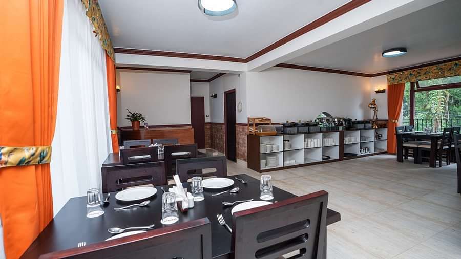 Image of a dining space with seating area and cutleries at Summit Sherpa Mountain Hotel & Spa, Kalimpong
