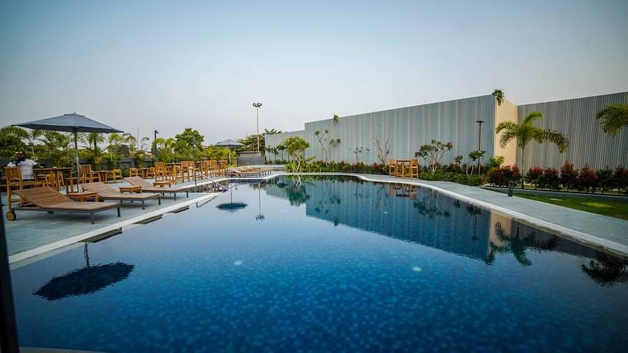 The outdoor swimming pool at Singalila Club with lounging chair setup beside it