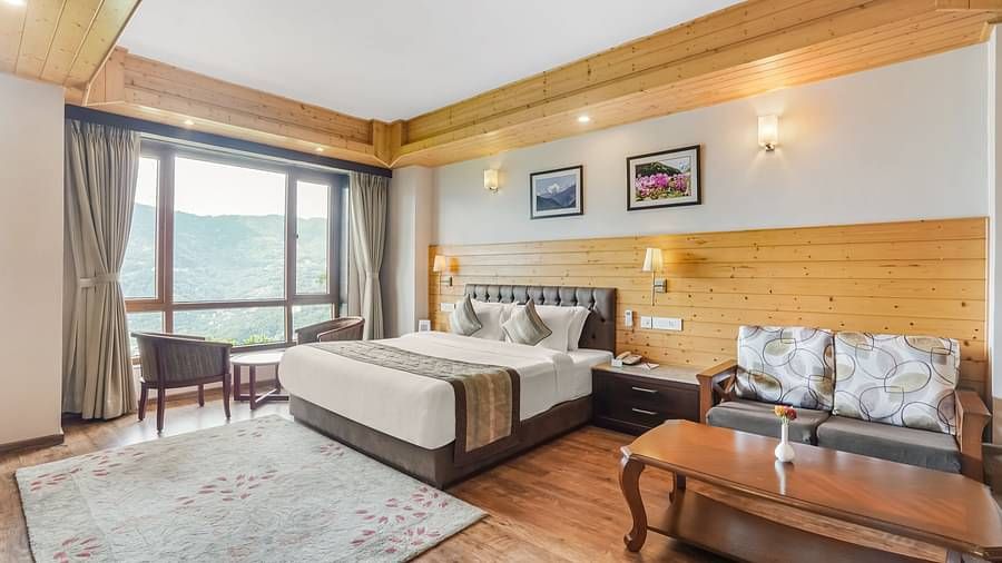 A room at Summit Alpine Abode with a double bed, a coffee table, sofa seating and a television