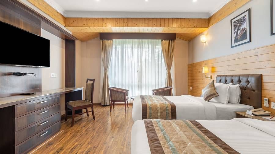 A room at Summit Alpine Abode with a twin beds, a television and French windows