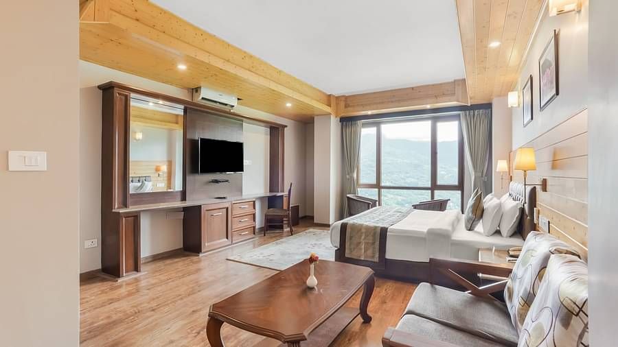 Suite at Summit Alpine Abode with a double bed, a coffee table, sofa seating and a television