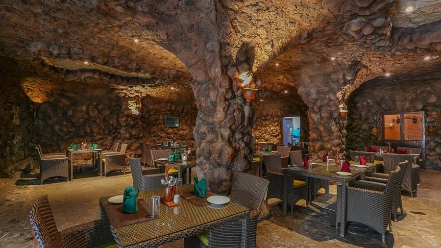 Kholong restaurant with a rock-themed décor, warm lighting, all tables, seating, and culinary arrangements arranged aesthetically2
