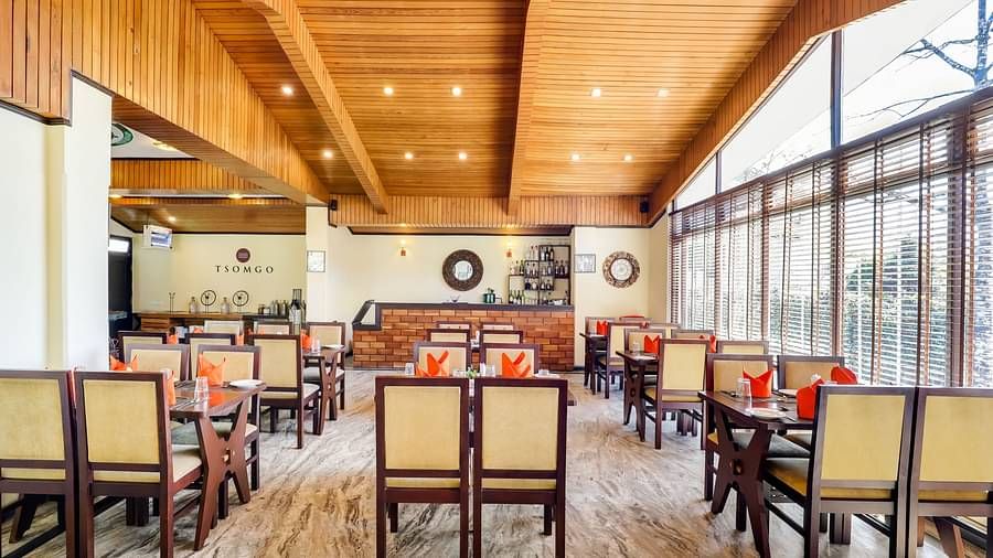 Tsomgo restaurant features cozy lighting, wooden tables and chairs, and culinary arrangements meticulously presented at Summit Norling Resort & Spa, Gangtok2